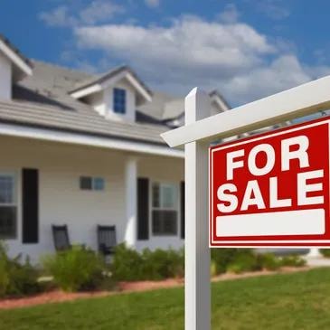 House with For Sale sign — pre-sale exterior cleaning