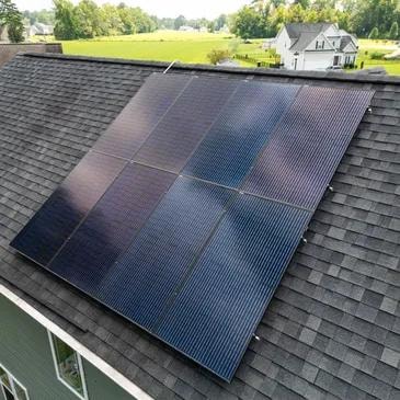 Solar panels on residential roof cleaned by drone
